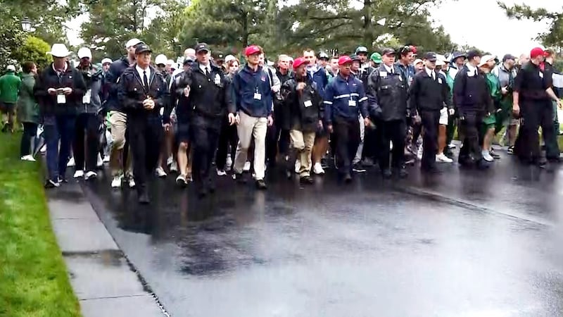 Security staff members guide patrons onto the grounds at Augusta National Golf Club on April...