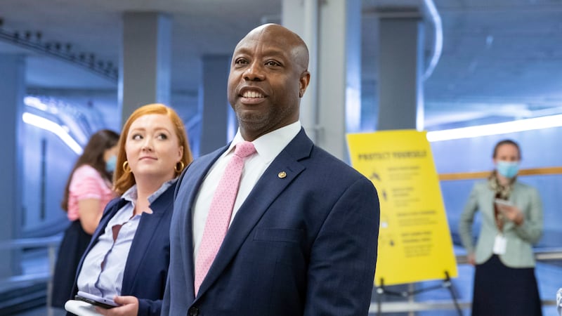 FILE - Sen. Tim Scott, R-S.C., speaks to reporters amid ongoing negotiations on the...