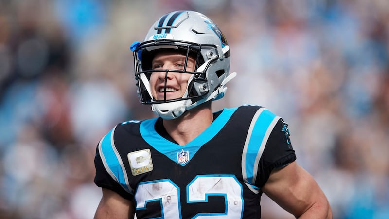 Carolina Panthers running back Christian McCaffrey (22) smiles after a touchdown during an NFL...