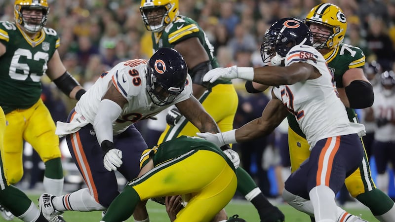 Green Bay Packers quarterback Aaron Rodgers is hurt after being sacked during the first half...