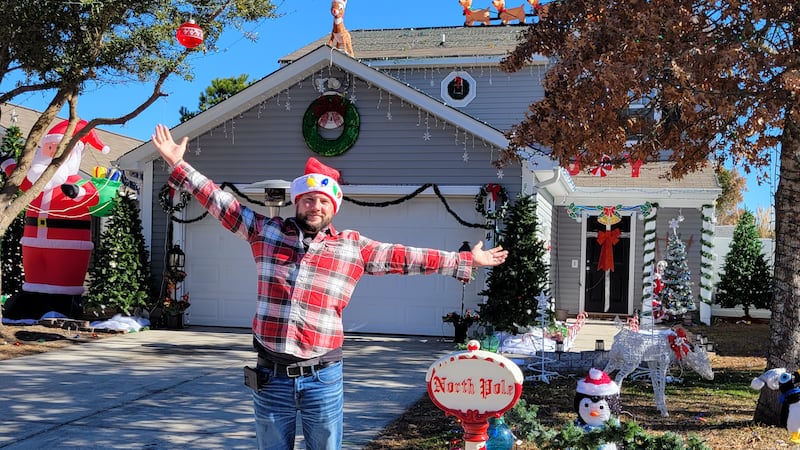 Brandon Runnells stands proudly behind his decorated home