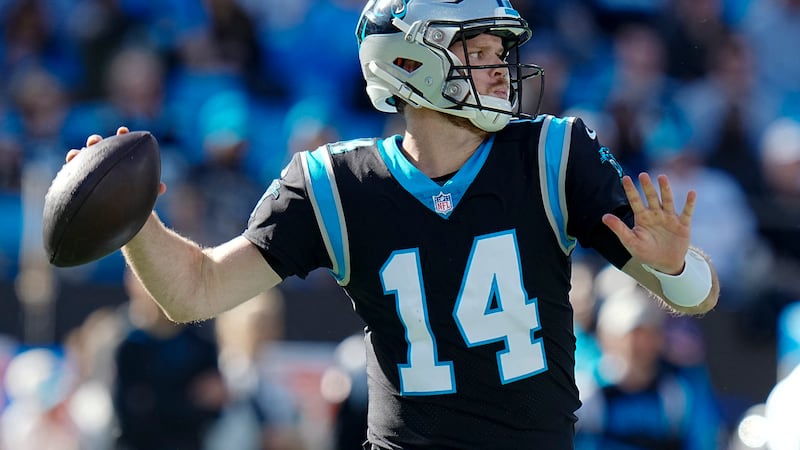Carolina Panthers quarterback Sam Darnold passes during the first half of an NFL football game...